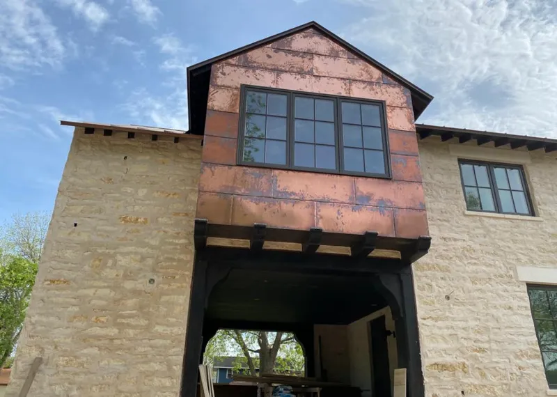 Copper metal panel facade on a stone building for Skylight Installation in Centennial