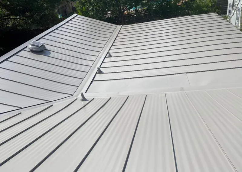Solar attic fan installed on a metal roof for Roof Ventilation in Centennial